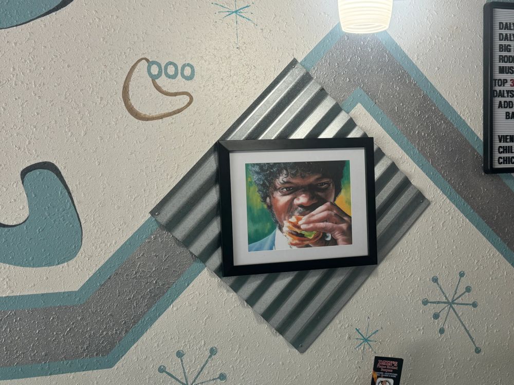 Eclectic pop-culture art on the wall inside Daly's retro diner